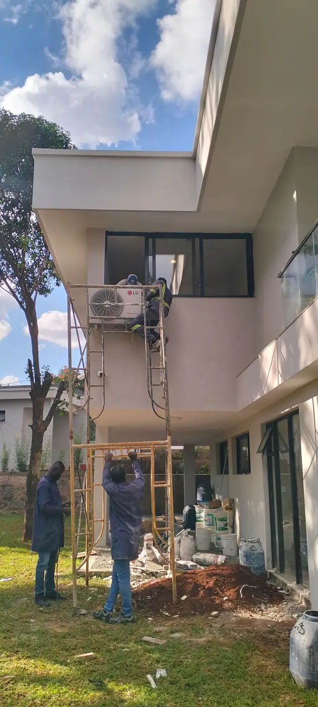 Technicians installing outdoor air conditioning equipment for an industry client